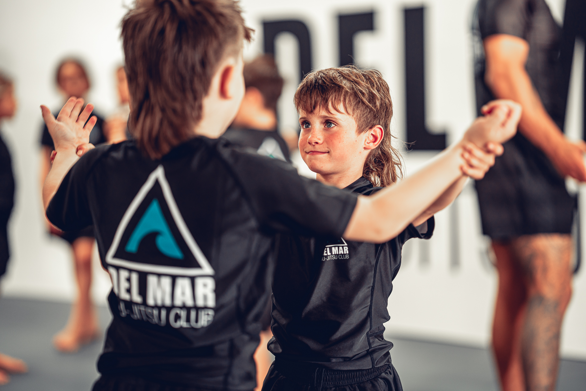 Two young students practicing a partner drill during a kids Jiu-Jitsu class